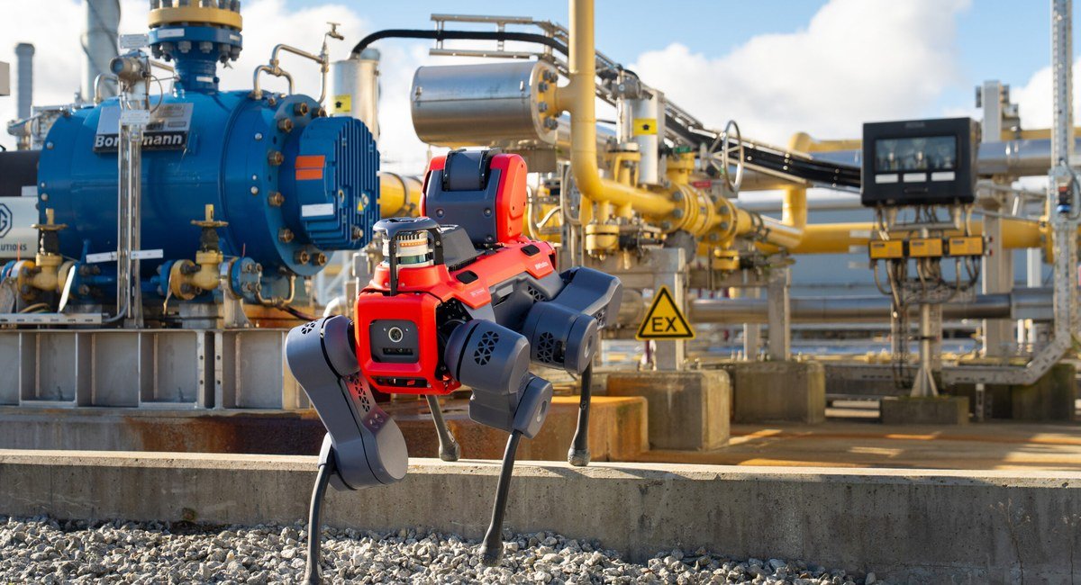 ANYmal X legged robot inspecting an industrial plant beside an EX zone sign