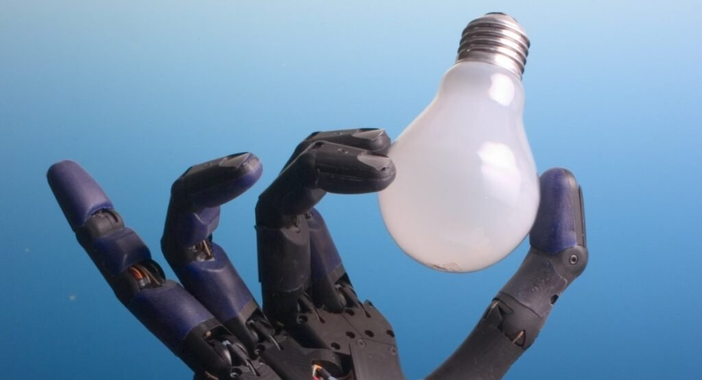 A dexterous robotic hand delicately holding a light bulb