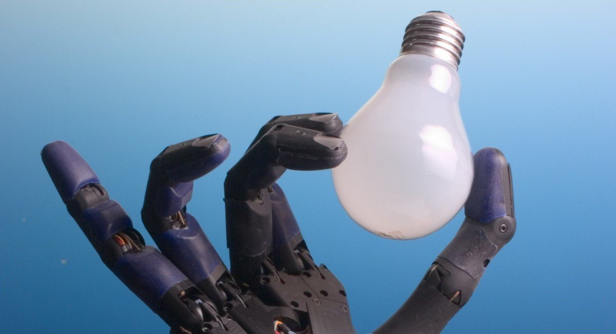 A dexterous robotic hand delicately holding a light bulb
