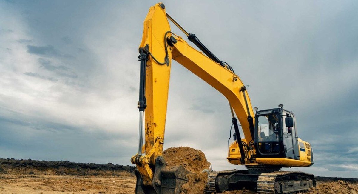 Yellow excavator digging at a construction site