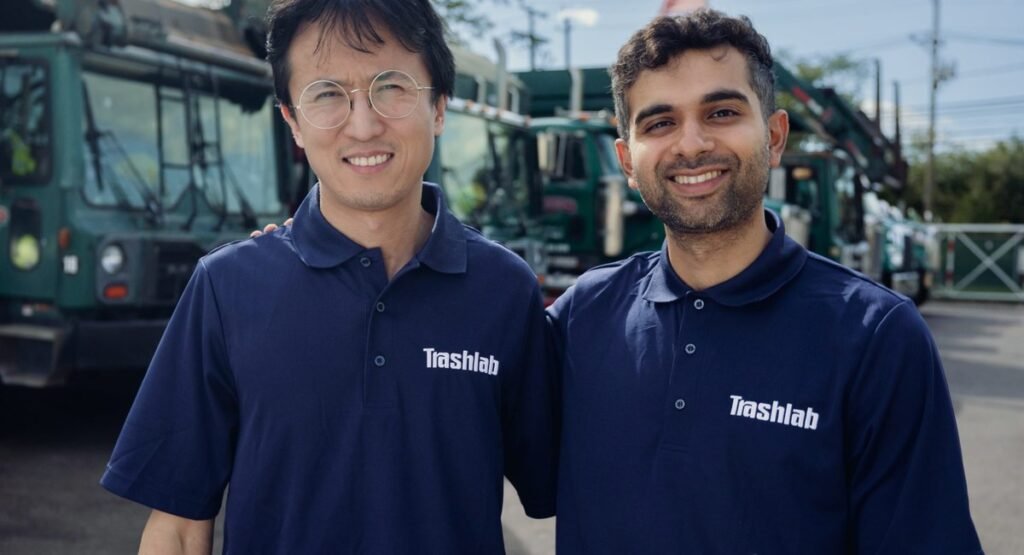 TrashLab founders John Tan and Neil Chaudhary in front of waste trucks